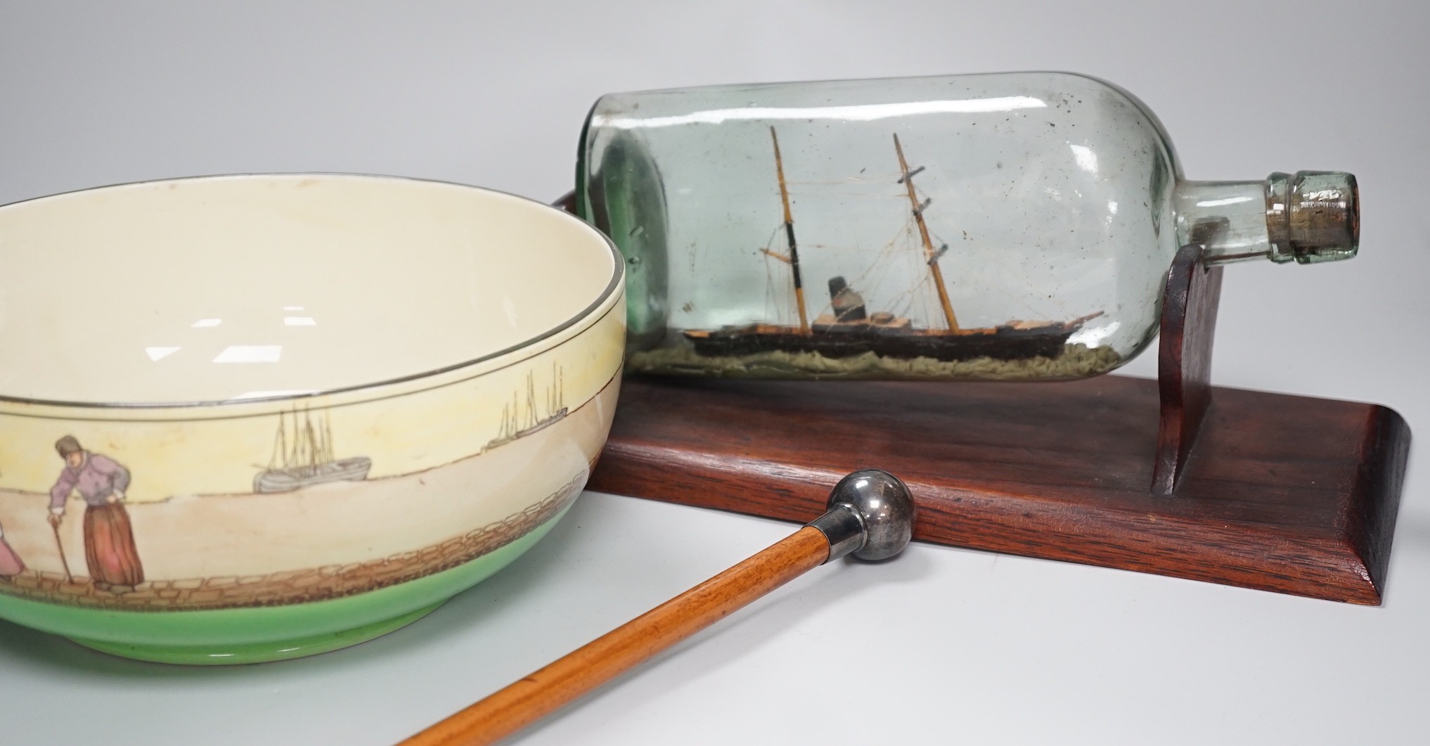A Royal Doulton series ware bowl, a ship in a bottle and a Gordon Highlanders white metal mounted swagger stick